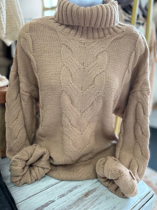 Suéter tejido de ochos con cuello alto y manga farol